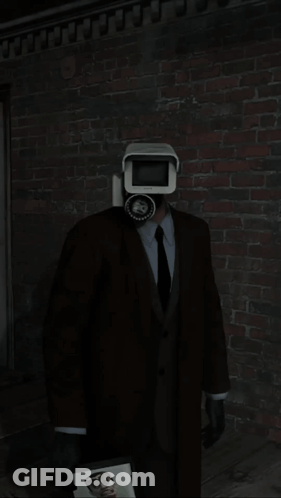 A Man In A Suit Is Standing In Front Of A Toilet GIF
