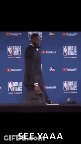 Man In Front Of NBA Finals Wall GIF