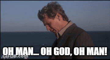 A Man In A Suit Is Standing In Front Of The Ocean And Says `` Oh Man Oh God Oh Man '' . GIF
