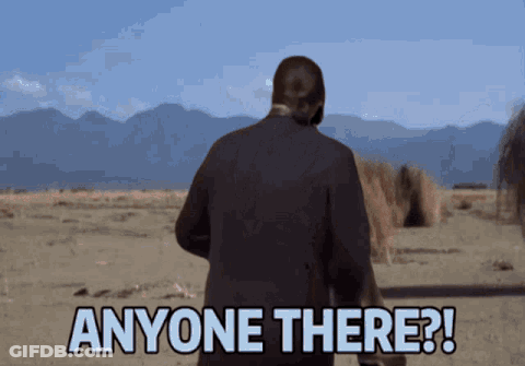 A Man In A Suit Is Standing In The Desert And Says Anyone There GIF
