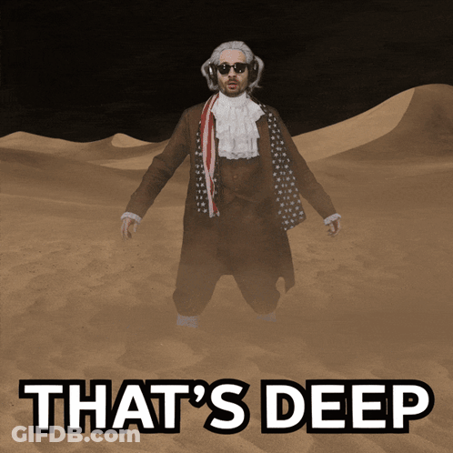 A Man In A Suit Is Standing In The Sand With The Words That 'S Deep Written Below Him GIF