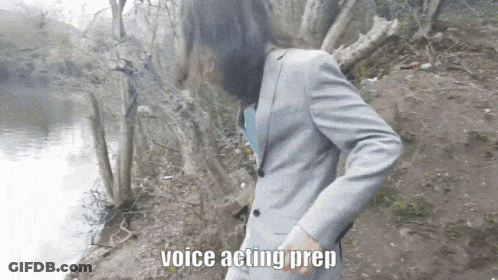 A Man In A Suit Is Standing Next To A Body Of Water And The Words Voice Acting Prep Are Above Him GIF