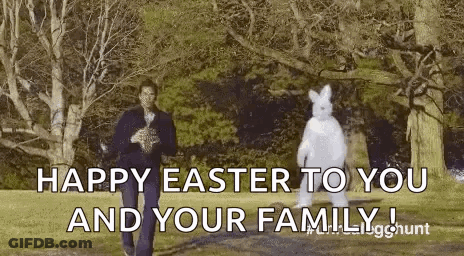 A Man In A Suit Is Standing Next To A Bunny In A Costume . GIF