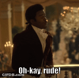 A Man In A Suit Is Standing On A Balcony And Says Oh-Kay Rude GIF