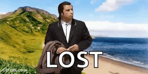 A Man In A Suit Is Standing On A Beach With The Word Lost Written On The Bottom Of The Picture . GIF