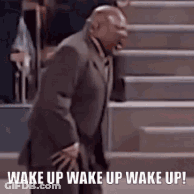 A Man In A Suit Is Standing On A Set Of Stairs And Says `` Wake Up Wake Up Wake Up '' . GIF
