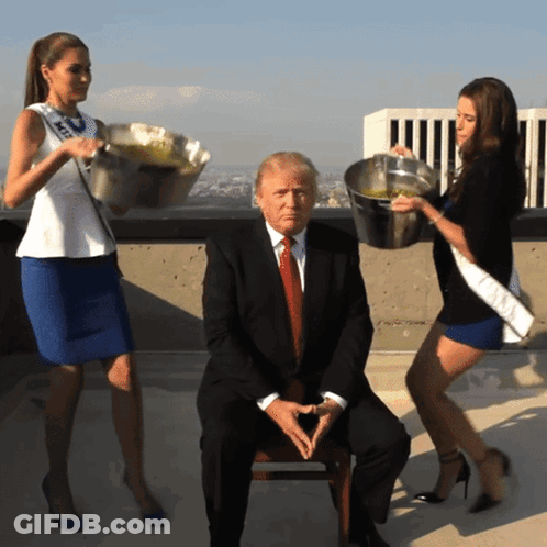 A Man In A Suit Is Surrounded By Two Women Carrying Buckets GIF