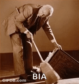 A Man In A Suit Is Sweeping The Floor With A Broom And A Bucket . GIF