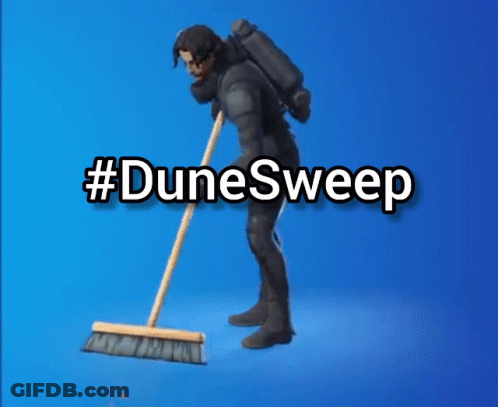 A Man In A Suit Is Sweeping The Floor With A Broom And The Words #Dunesweep Behind Him GIF