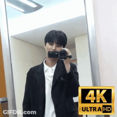 A Man In A Suit Is Taking A Picture Of Himself In A 4K Ultra Hd Photo GIF