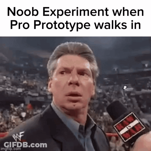 A Man In A Suit Is Talking Into A Microphone At A Wrestling Match . GIF