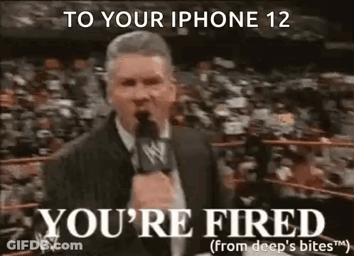 A Man In A Suit Is Talking Into A Microphone In A Wrestling Ring . GIF
