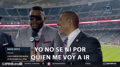 A Man In A Suit Is Talking Into A Microphone While Another Man Says Yo No Se Ni Por GIF