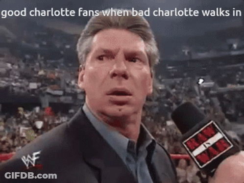A Man In A Suit Is Talking Into A Microphone With The Words " Good Charlotte Fans When Bad Charlotte Walks In " Above Hi GIF