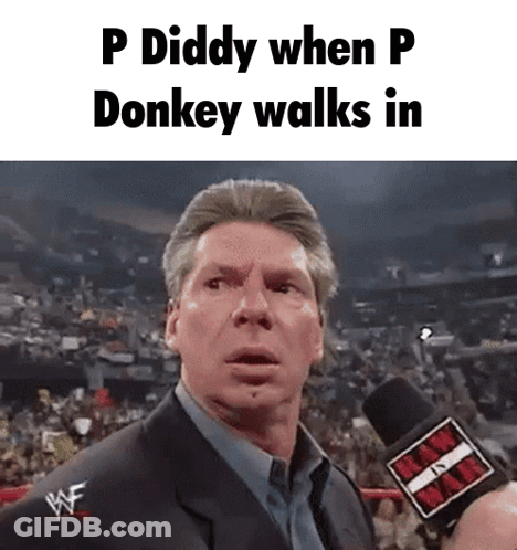 A Man In A Suit Is Talking Into A Microphone With The Words P Diddy When P Donkey Walks In . GIF