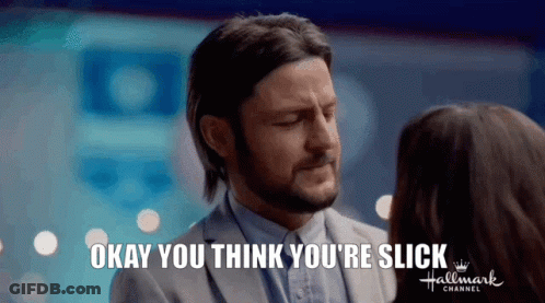 A Man In A Suit Is Talking To A Woman In A Hallmark Channel Ad . GIF