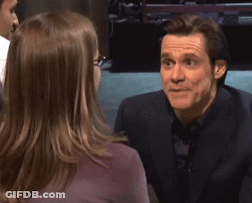A Man In A Suit Is Talking To A Woman With The Words Money Money Written Above Him GIF
