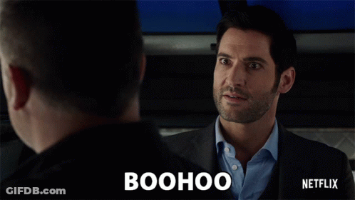 A Man In A Suit Is Talking To Another Man And The Word Boohoo Is Above Him GIF