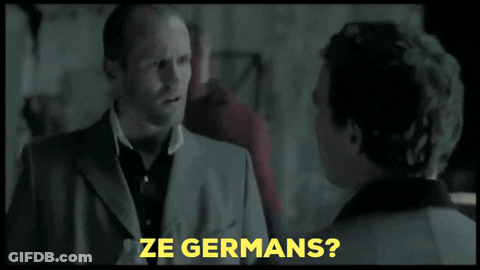 A Man In A Suit Is Talking To Another Man And The Words Ze Germans Are Visible GIF