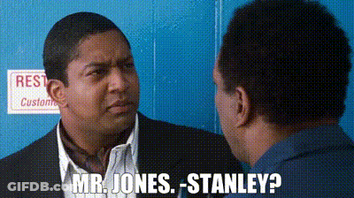 A Man In A Suit Is Talking To Another Man In A Blue Shirt And Says Mr. Jones Stanley . GIF