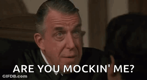 A Man In A Suit Is Talking To Another Man In A Courtroom And The Man Is Asking The Judge If He Is Mocking Him GIF