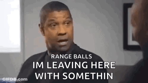 A Man In A Suit Is Talking To Another Man In A Room . GIF