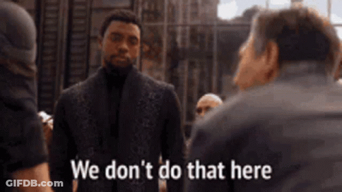 Suit Man Talking To Another Man N Saying We Don't Do That Here GIF