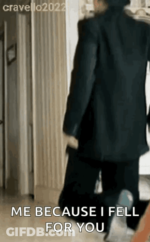 A Man In A Suit Is Walking Down A Hallway And Saying `` Me Because I Fell For You '' GIF