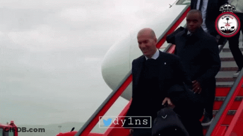 A Man In A Suit Is Walking Down A Set Of Red Stairs With The Hashtag Dy1ns On The Bottom GIF
