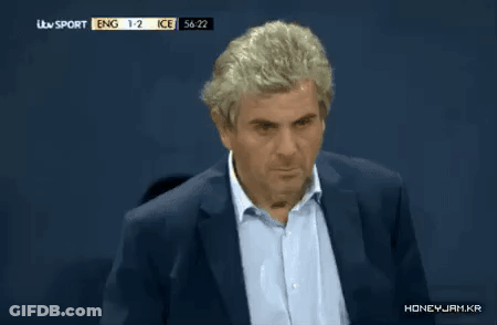 A Man In A Suit Is Watching A Soccer Game Between Ice And Eng GIF