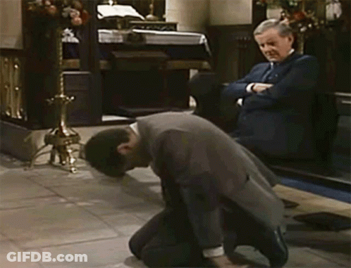 A Man In A Suit Kneels Down In Front Of Another Man GIF
