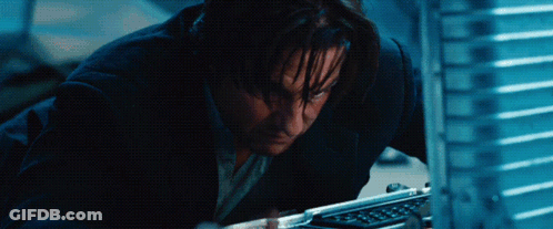 A Man In A Suit Looks At A Computer Screen GIF