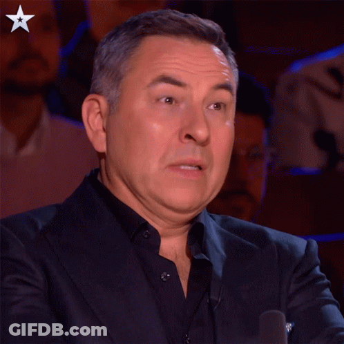 A Man In A Suit Making A Funny Face With A Star In The Corner GIF