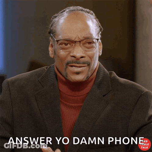 A Man In A Suit Making A Phone Call With His Hand And The Words Answer Yo Damn Phone Below Him GIF