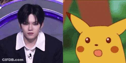 A Man In A Suit Next To A Picture Of A Cartoon Character GIF