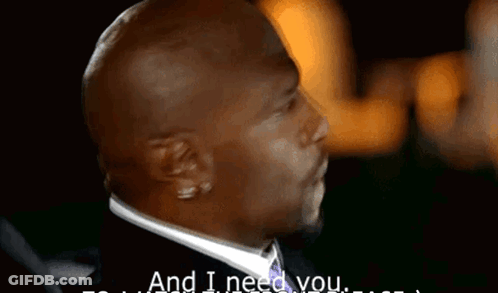 A Man In A Suit Says " And I Need You " In A Dark Room GIF