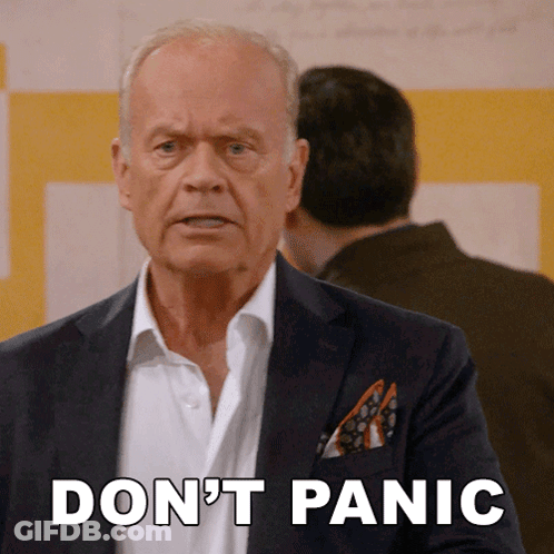 A Man In A Suit Says " Don 'T Panic " GIF