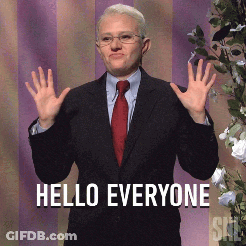 A Man In A Suit Says Hello Everyone With His Hands Up GIF