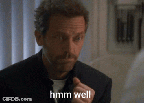 A Man In A Suit Says Hmm Well GIF