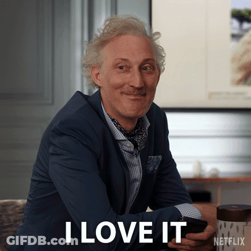 A Man In A Suit Says I Love It While Holding A Cellphone GIF