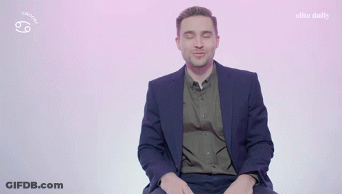 A Man In A Suit Says I 'M A Cancer On A Pink Background GIF