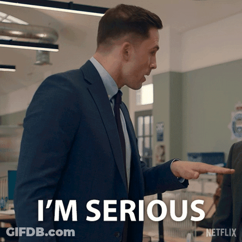 A Man In A Suit Says I 'M Serious While Pointing GIF