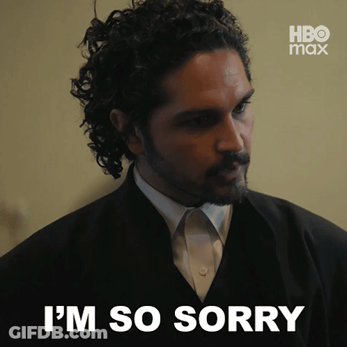 A Man In A Suit Says I 'M So Sorry In Front Of A Hbo Max Logo GIF