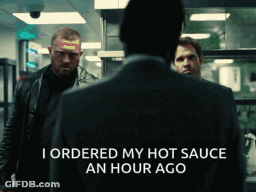 A Man In A Suit Says I Ordered My Hot Sauce An Hour Ago In A Dark Room GIF