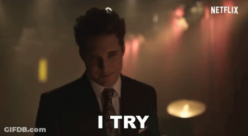 A Man In A Suit Says I Try In Front Of A Netflix Logo GIF