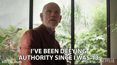 Man In Suit Saying I've Been Defying Authority Since 13 GIF