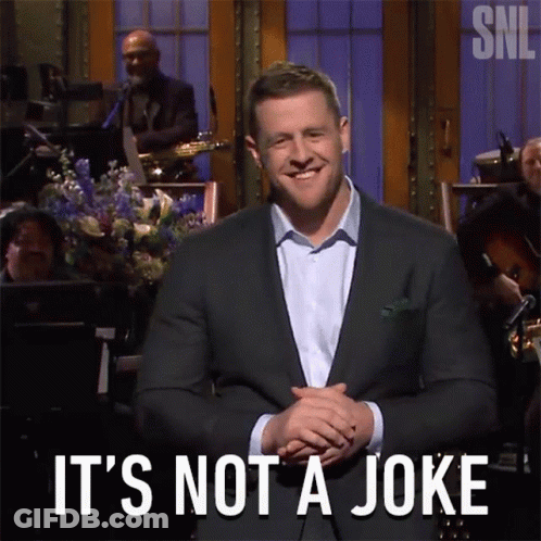 A Man In A Suit Says " It 'S Not A Joke " In Front Of An Orchestra GIF