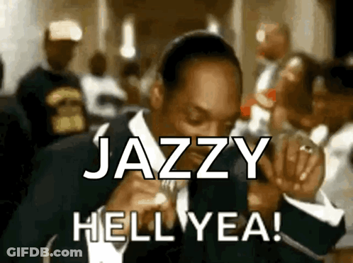 A Man In A Suit Says Jazzy Hell Yea In Front Of A Crowd Of People GIF