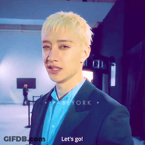 A Man In A Suit Says Let 'S Go In Front Of A Screen GIF