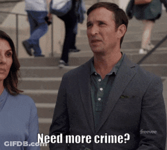A Man In A Suit Says Need More Crime While Standing Next To A Woman GIF